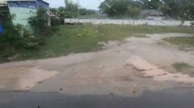 Countryside of Cambodia view out of a bus window, motorbikes, cloudy rainy weather. High quality FullHD footage