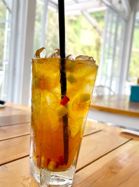 新鮮なミックスフルーツカクテル酒とラム酒とウィスキーをグラスに入れて木のテーブルの上に氷の塊 — ストック写真