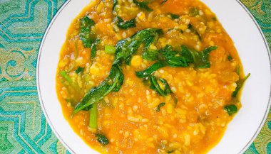tinutuan, bubur manado, indonesian traditional porridge dish mixed of rice, pumpkin, and kangkung vegetable served with salty fish and sambal