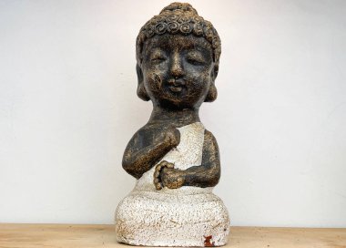 Small statue decorations for table and interior, little buddha statue modern simplistic house environment with several pottery and wooden table