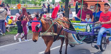 Surakarta, Endonezya, 8 Ocak 2023 Dokar Wisata ya da savaş arabası gezisi, Surakarta, merkez java 'da pazar günü serbest araba alanında yolcuları bekliyor.