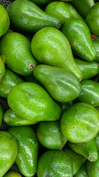 fresh produce of green avocados at the local market, healthy fresh fruit for salad or juice or guacamole