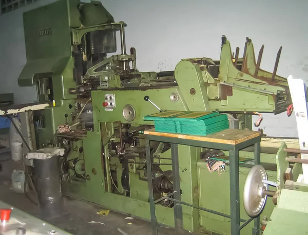 machines on a large printing plant factory, printing of books bad working conditions in asia sweat shop factory