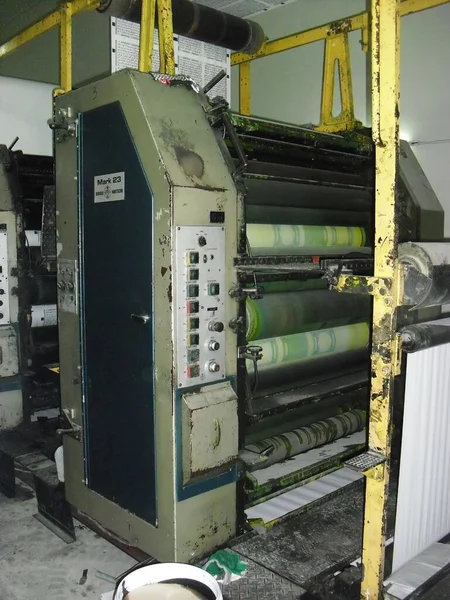 machines on a large printing plant factory, printing of books bad working conditions in asia sweat shop factory