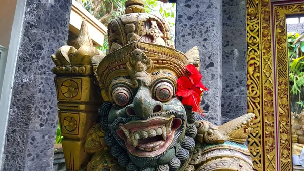 figure guarding the entrance to a Hindu temple, statue of sacred temple in Bali, balinese temple guardian, balinese gnome, Traditional Balinese statues or called Arca made of stone carvings in the form of gods, people or demons. Balinese sculpture in