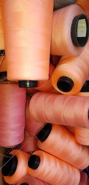 Group of colorful yarn on spool, yarn on tube, cotton, wool, linen thread orange colorful used in fashion