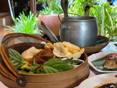 Sundan hindistancevizi pirinç paketi ya da eşsiz Sundan mutfağıyla Batı Java 'dan Nasi Liwet Sunda ngeliwet ya da botram adı verilen Sundan yemek geleneğinin farklı bir tadı ve sunumu kızarmış tavuk, sambal, satay, kraker, kızarmış 