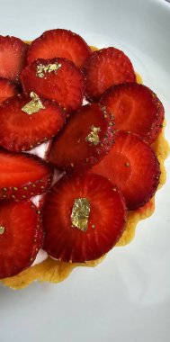 Lezzetli çilekli tart ya da çilekli tart ve yenilebilir altın taneleriyle süslenmiş krema. Multimedya tarifi içeriği yaratmak için iyi.