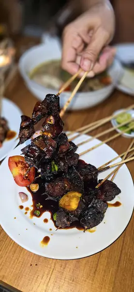 stock image grilled mutton or lamb satay, or local Indonesian called Sate Kambing or known as Mutton meat Satay cooked in traditional stove, good for digital recipe content creation