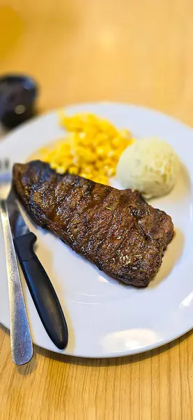 stock image Luxurious glorious sirloin steak dinner with premium sides a feast for the senses along with potatoes, sauces and condiments good for recipes and cook book content creation