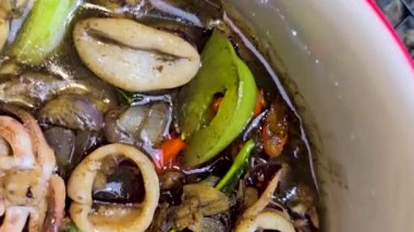 Tumis Cumi Hitam adında baharatlı siyah mürekkep soslu sotelenmiş mürekkep balığı, Chili, zencefil ve limon yaprağı da dahil olmak üzere Endonezya ev yapımı yemek menüsü.