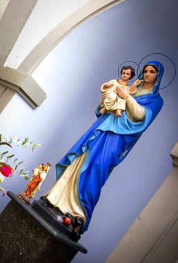 Mother Mary sacred peaceful prayer place, blessed Virgin Mary statue, praying Virgin Mary statue. Religious background on church interior background, a solitary place for praying clipart