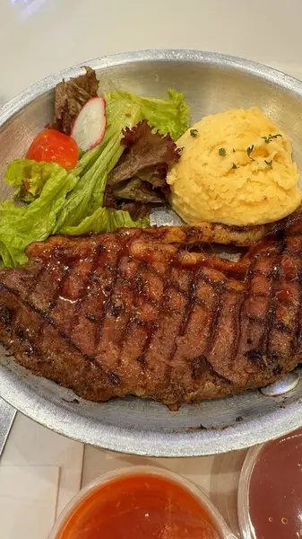 stock image Luxurious and glorious sirloin steak dinner with premium sides a feast for the senses along with potatoes, sauces and condiments good for recipes and cook book content creation