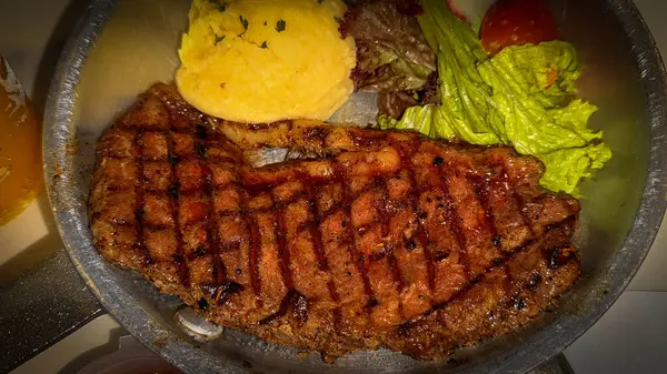 stock image Luxurious and glorious sirloin steak dinner with premium sides a feast for the senses along with potatoes, sauces and condiments good for recipes and cook book content creation