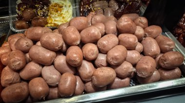 Lezzetli, parlak renkli sosisler Tayland 'daki bir yemek festivalinde gösterişli bir şekilde istiflenmiş. Mutfak zevkini ve hoşgörüyü çağrıştırıyor..