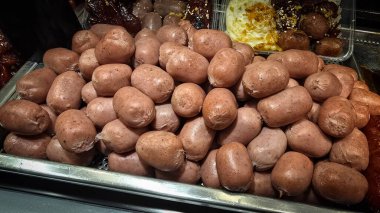 Lezzetli, parlak renkli sosisler Tayland 'daki bir yemek festivalinde gösterişli bir şekilde istiflenmiş. Mutfak zevkini ve hoşgörüyü çağrıştırıyor..