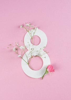 Postcard March 8 on a pink background. Pink background with roses and gypsophila