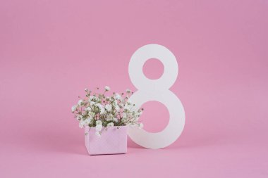 8 numaralı kağıt yapıldı. 8 Mart 'ta hediye kutusunda çiçek dekoru olan bir kartpostal. Kadınlar Günü konsepti. Gül ve çingene