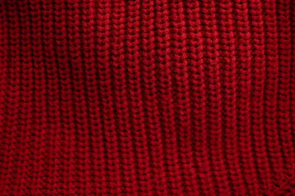 Red knitted sweater texture background, space for text