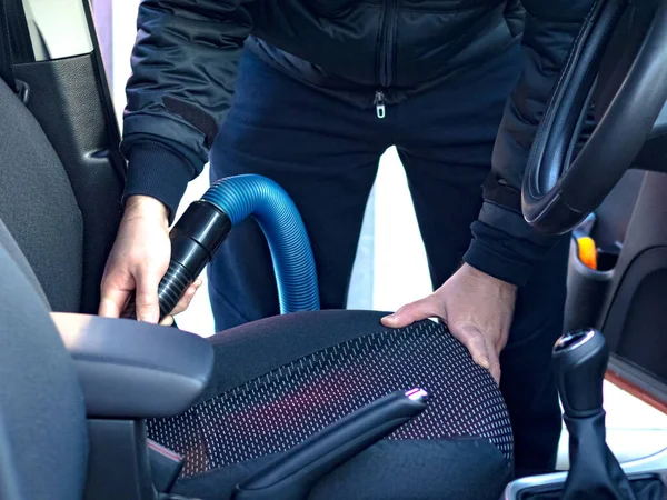 stock image Cleaning the car interior with a vacuum cleaner