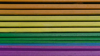 Colorful wooden bench, LGBT pride, unity symbol, public park seating clipart