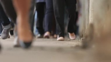 a close-up of walking legs. Legs of Crowd People Walking on the Street.