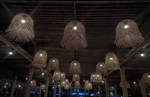 Decorative lamps made of bamboo hang from the ceiling