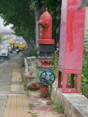 Yangın musluğu, yangın musluğu hareketli bir caddede dimdik duruyor. Güvenliği simgeliyor, acil durum hazırlığını simgeliyor.