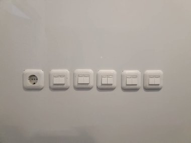 Jakarta, Endonezya - 16 Ağustos 2024: beyaz beton duvarda ışık düğmesi. Boşluğu kopyala