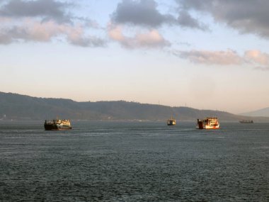 Bali, Indonesia - 15 August, 2024 : The atmosphere of ferry traffic at the Gilimanuk ferry port in the morning. clipart