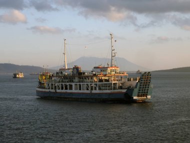 Bali, Indonesia - 15 August, 2024 : The atmosphere of ferry traffic at the Gilimanuk ferry port in the morning. clipart