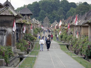 Bali, Indonesia - August 17, 2024: crowds of tourists visit panglipuran village which is the cleanest village in the world.  clipart