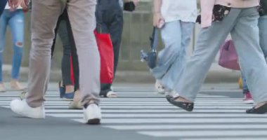 Close up of office workers' feet crossing at a zebra crossing in Jakarta, Indonesia August 20, 2025