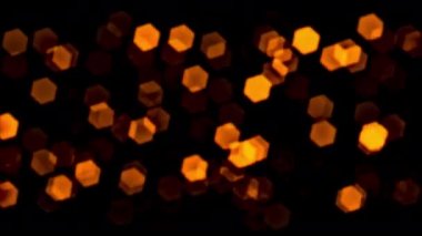 4K 3D döngü turuncu bokeh parçacıkları parlaklığı animasyon karanlık arkaplan proje ekran örtüsü için soyut. Soyut hareket arkaplan parlayan parçacıklar büyülü altın bokeh ışık dalgaları festival etkisi için uzayda merkez akışından geliyor. 