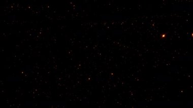 Turuncu parlak turuncu yıldız parçacıkları, ekran projesi örtüşmesi için siyah arkaplan akışında animasyon yaparlar. Galaksi gökyüzü parçacıkları parlayan ışık parçacıklarıyla grafiksel hareket örtüşme etkisi döngüsü 