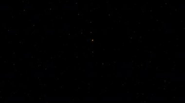 Ekran projesi için parlayan altın yıldız parçacıkları siyah zemin üzerinde hareket animasyonu. Altın soyut ışıltılar Noel kış karını aydınlatıyor. 