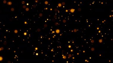Güzel döngü animasyonu, siyah soyut arka planda yüzen altın turuncu bokeh parçacıkları parıldatır. Kış Noel 'i için yeni yıl temalı 4K kusursuz döngü