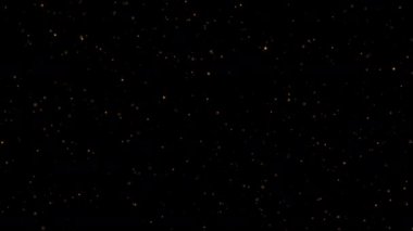 Güzel animasyon döngüsü yanıp sönen altın yıldız parçacıkları siyah soyut arka planda akar. Siyah arkaplan hareketindeki altın yıldız parçacığı başlıkları sinematik arkaplan döngüsü. 