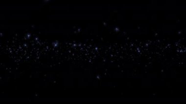 Soyut arkaplan döngüsü, parlak mavi yıldız parçacıkları siyah arkaplanda yükseliyor. Kış tatili arka plan kavramı, Mutlu Noeller., 