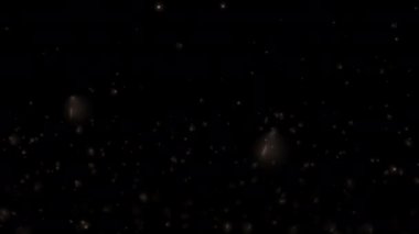 Soyut döngü parlayan toz parçacıkları siyah arkaplanda yükseliyor. Kış tatili arka plan kavramı, Mutlu Noeller., 