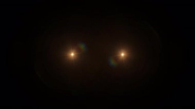 Soyut turuncu optik ışık parlamaları siyah arkaplandaki animasyona doğru hareket ediyor. 4K kusursuz döngü dinamik kinetik parlak yıldız ışığı etkisi.