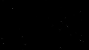 Siyah soyut arka planda parlayan beyaz toz yıldızı parçacıkları. Alevli, yeşil, parlayan, yanan kül parçacıklarının canlandırması.