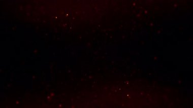 Soyut döngü animasyonu yanıp sönen turuncu altın toz parçacıkları siyah arkaplanda yüzüyor. Kusursuz turuncu bokeh parçacıkları havada uçuşuyor.. 