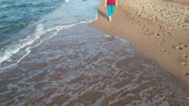 walking on beach, aerial man walking on the beach, by sea