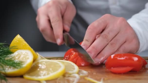 トマトを切り マスターは台所で食べ物を準備しています — ストック動画