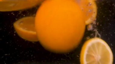 orange and lemons, orange and lemons splashing in water