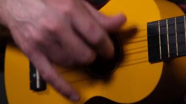 ukulele, man playing ukulele instrument close up