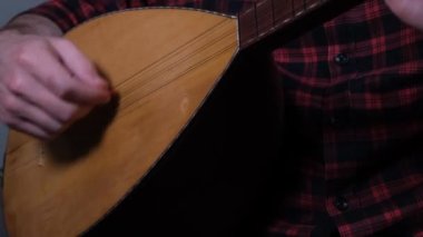 turkish saz, man playing turkish saz instrument