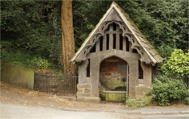 Great Budworth, Cheshire West and Chester, UK - August 17th 2024 - old wooden structure covering a natural water spring at the side of the road clipart