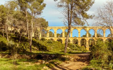 Tarragona, Spain - December 24th 2024 - Looking down the valled at the ancient Roman viaduct dating back to the 1st Century clipart